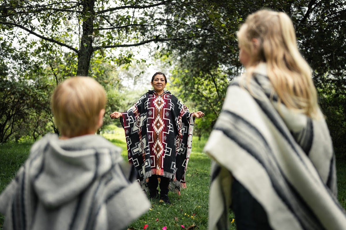 Visitors taking part in an Andean cultural ceremony